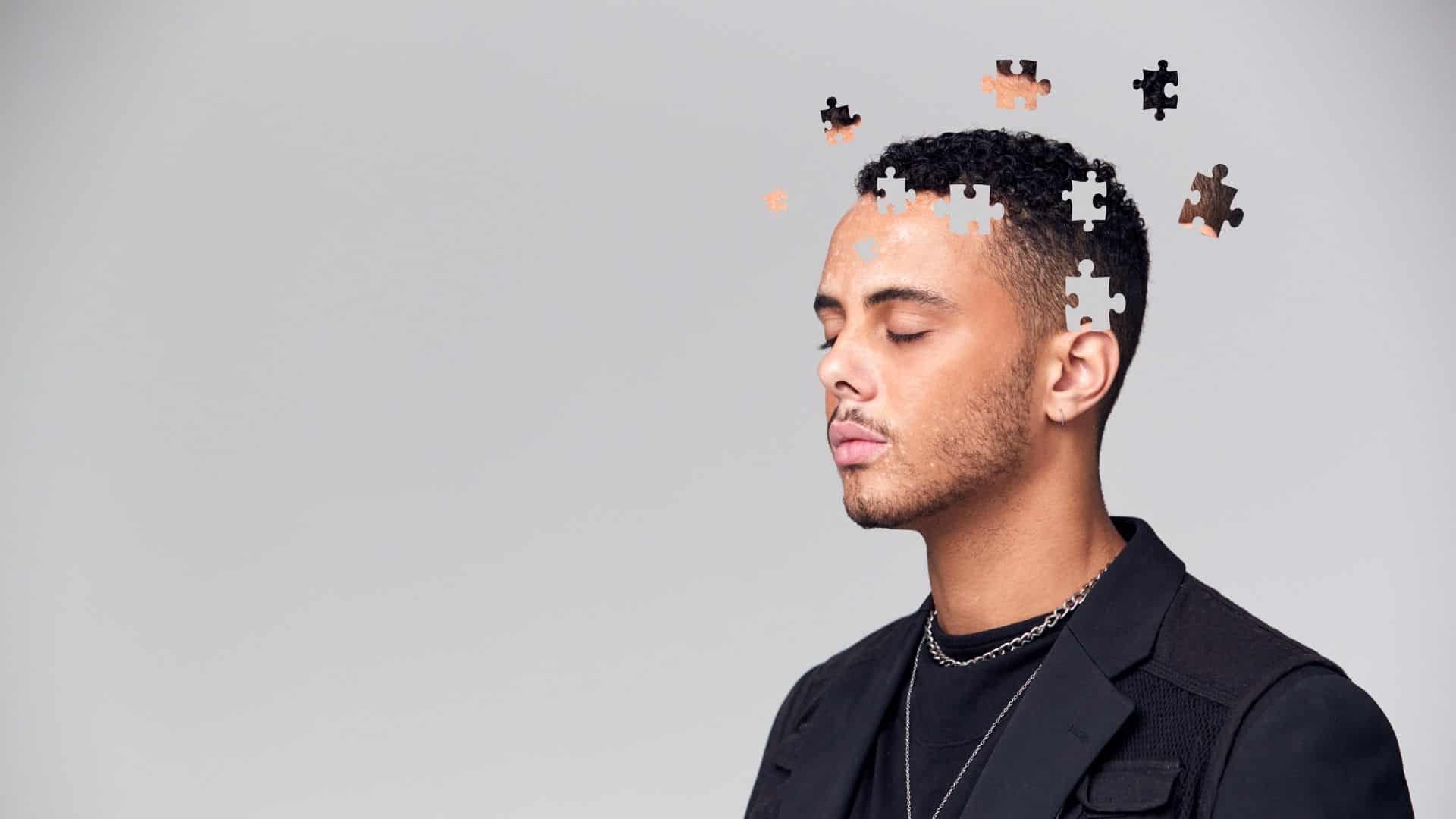 stock image showing a man with puzzle pieces coming out of his head