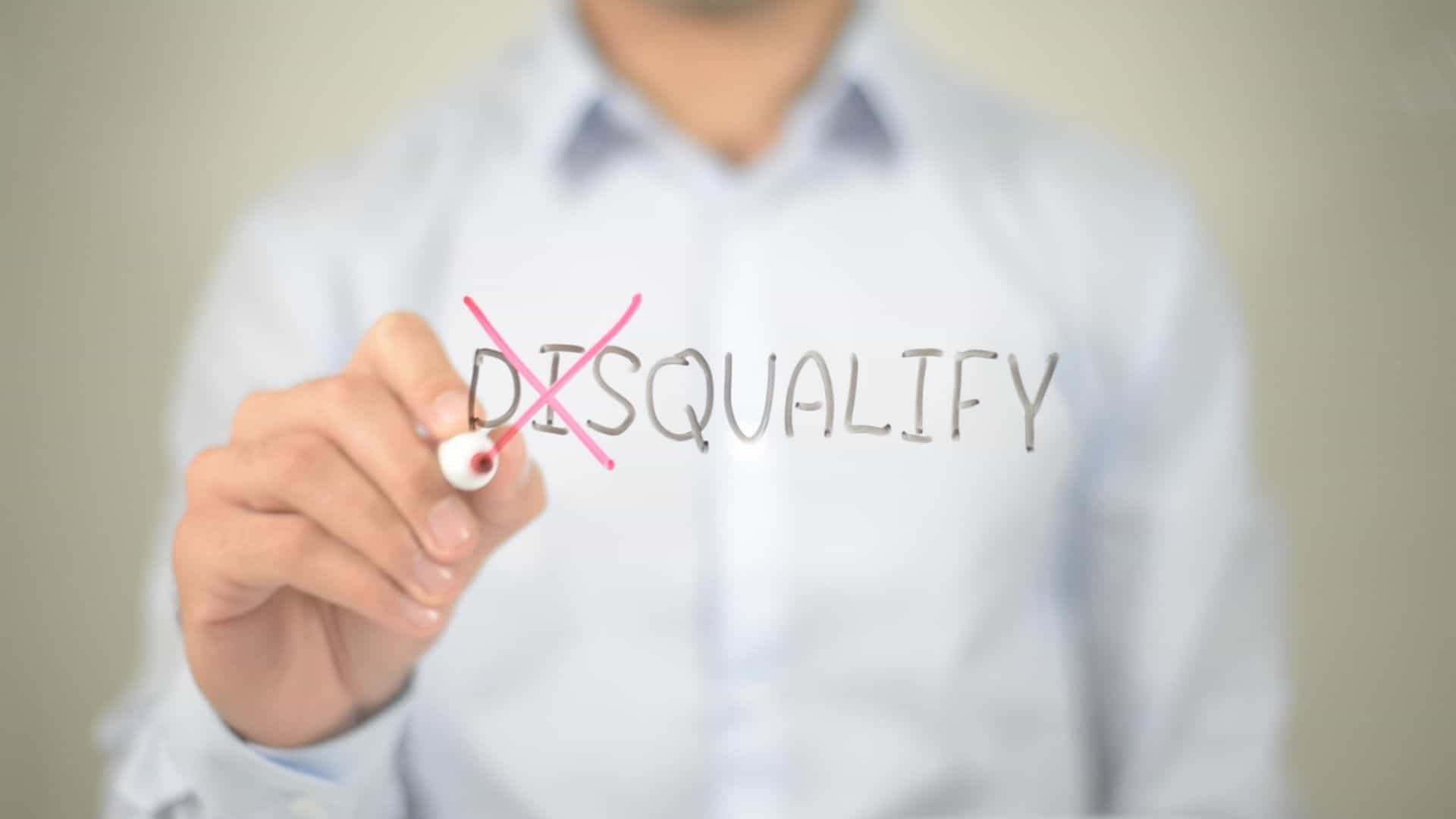 stock image showing a man in a button down shirt crossing out the